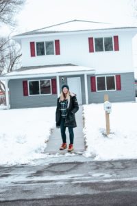 Woman in front of Central MN Habitat for Humanity built home
